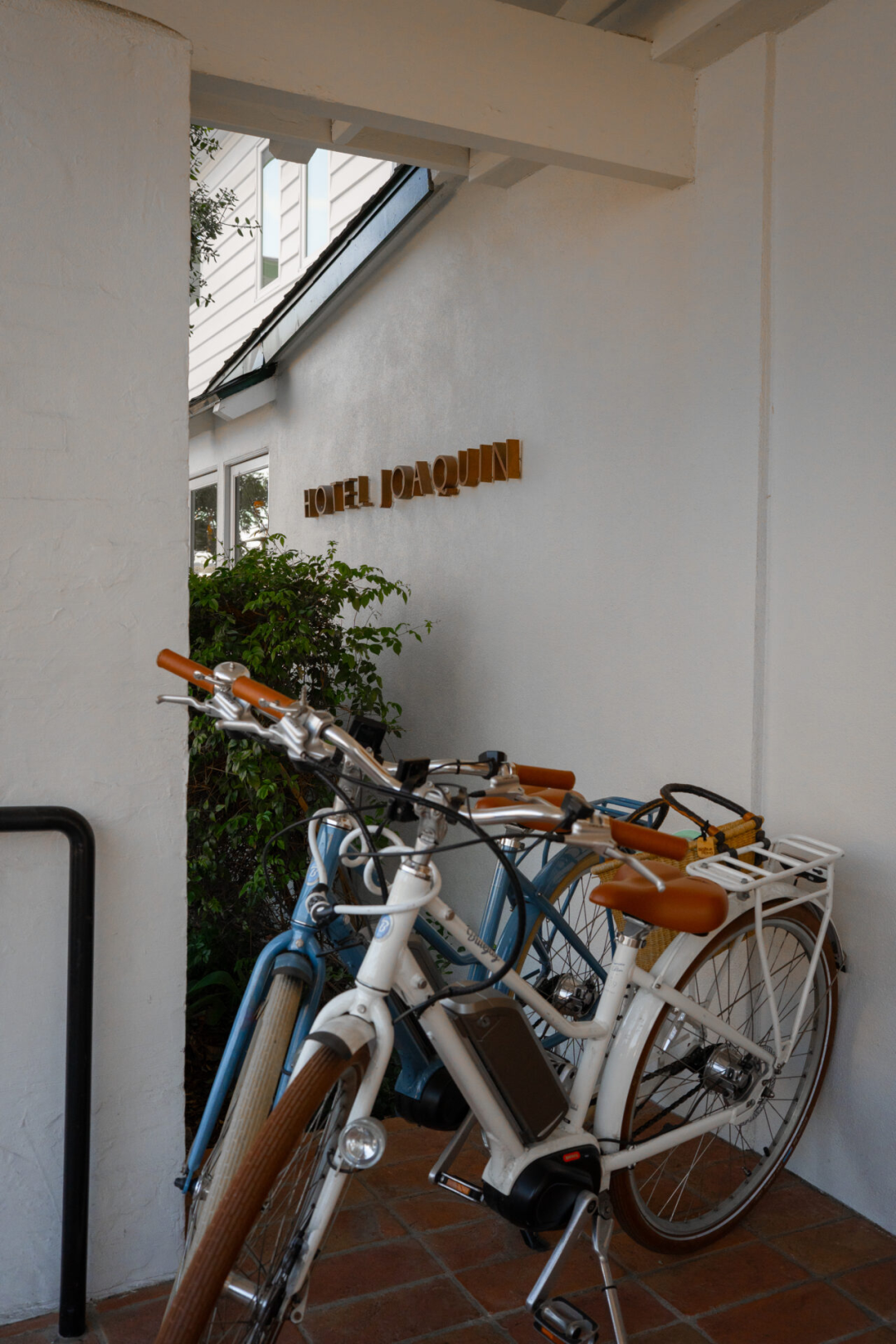 Laguna Beach Weekend Trip: a set of blue and white beach cruisers outside the Hotel Joaquin porch