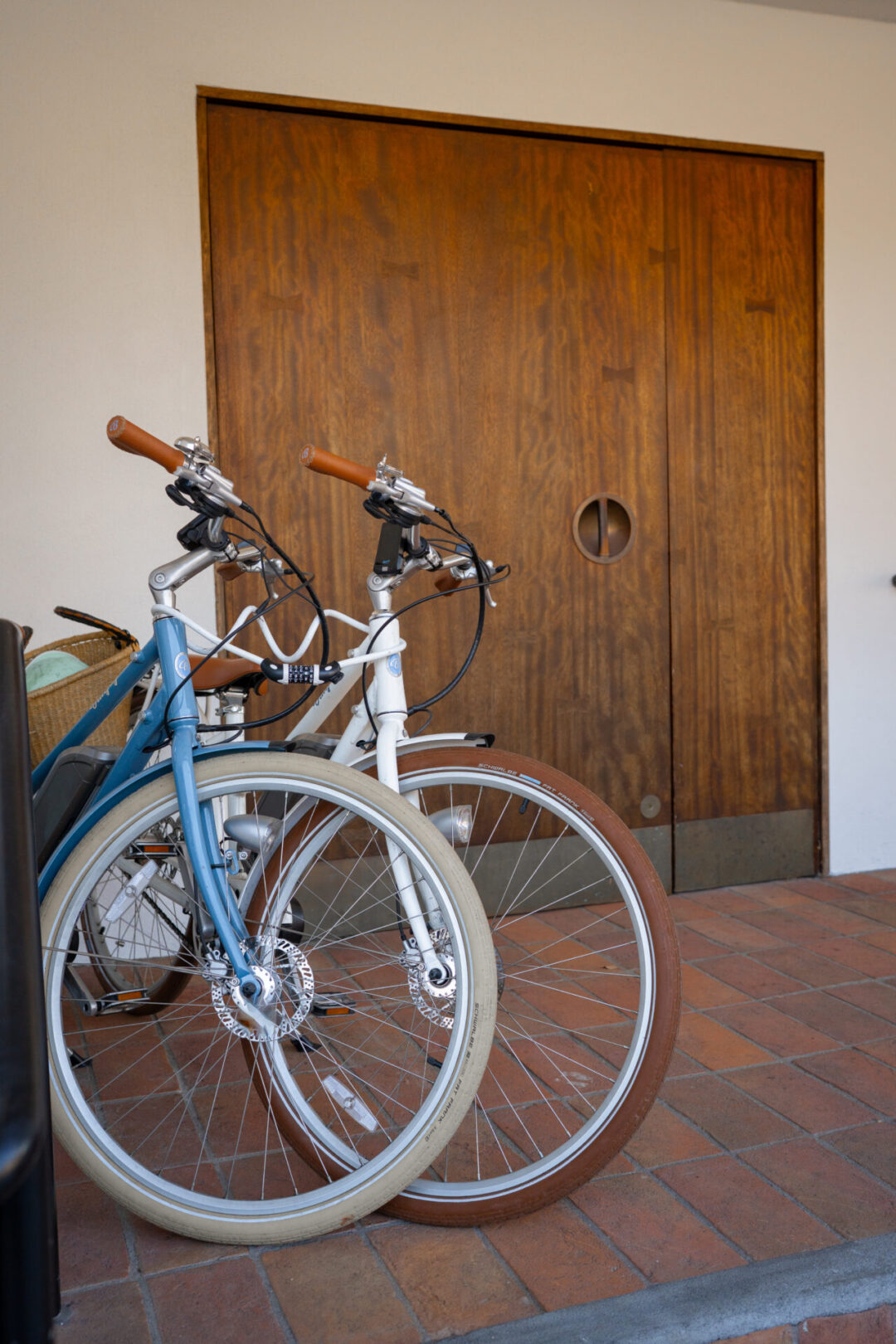 A blue beach cruiser and a white beach cruiser outside Hotel Joaquin in Laguna Beach, California