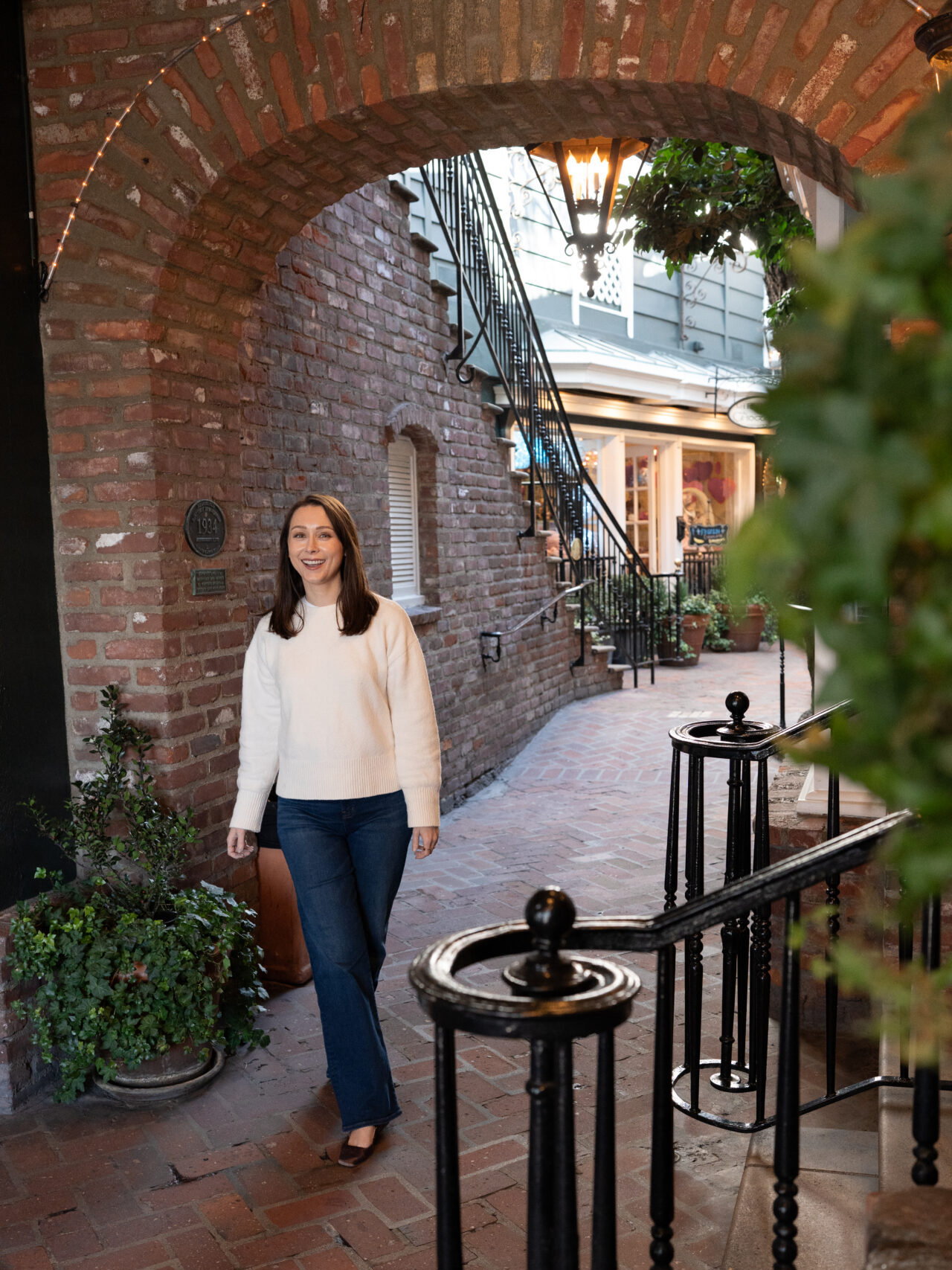 Travel Blogger Jordan Gassner smiling inside the European-inspired Peppertree Lane in Laguna Beach, California