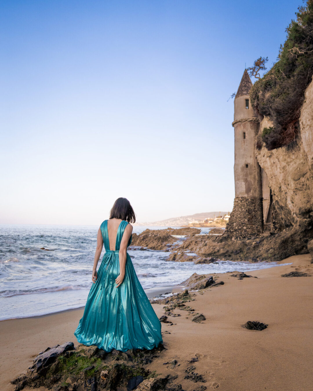 Travel Blogger Jordan Gassner walking up to Pirate Tower on Victoria Beach in Laguna Beach, California