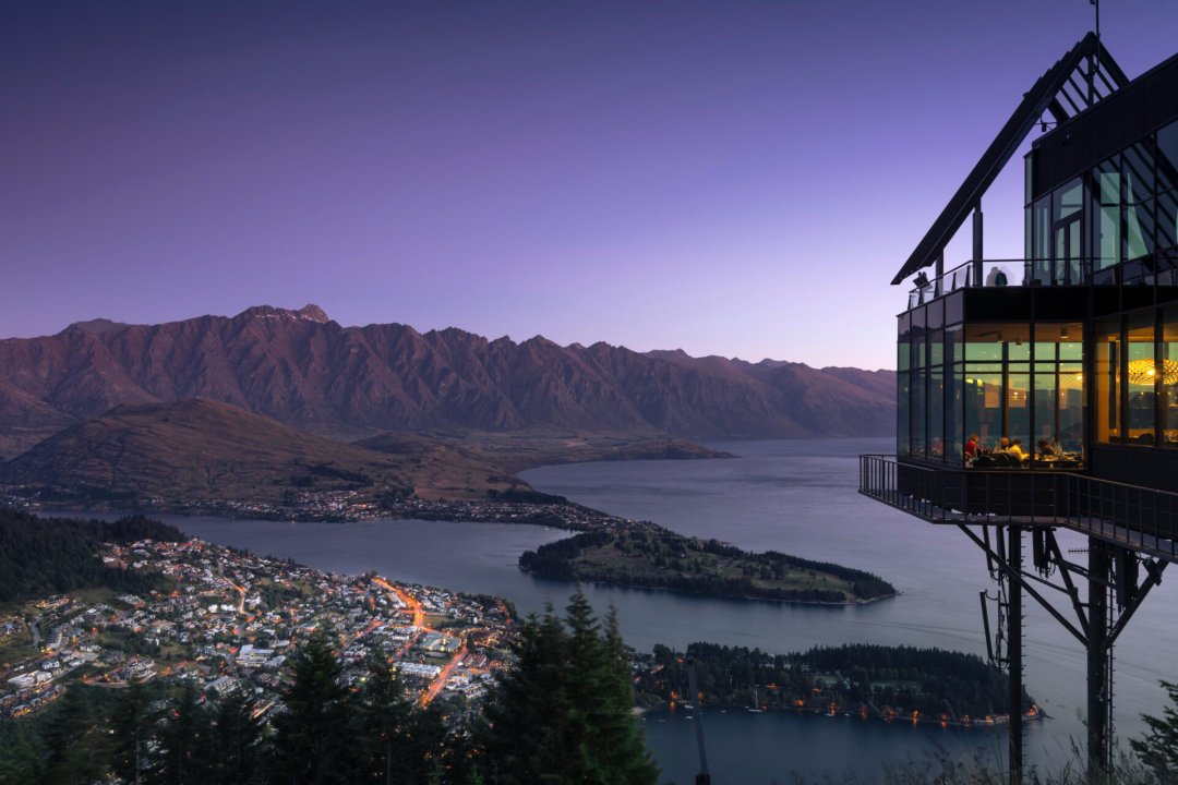 The Stratosfare Restaurant at the top of the Skyline Gondola overlooking Queenstown New Zealand at dusk