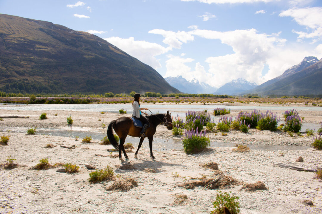 Travel Blogger Jordan Gassner riding a horse through the area that Isengard from the Lord of the Rings movies were filmed near Queenstown, New Zealand