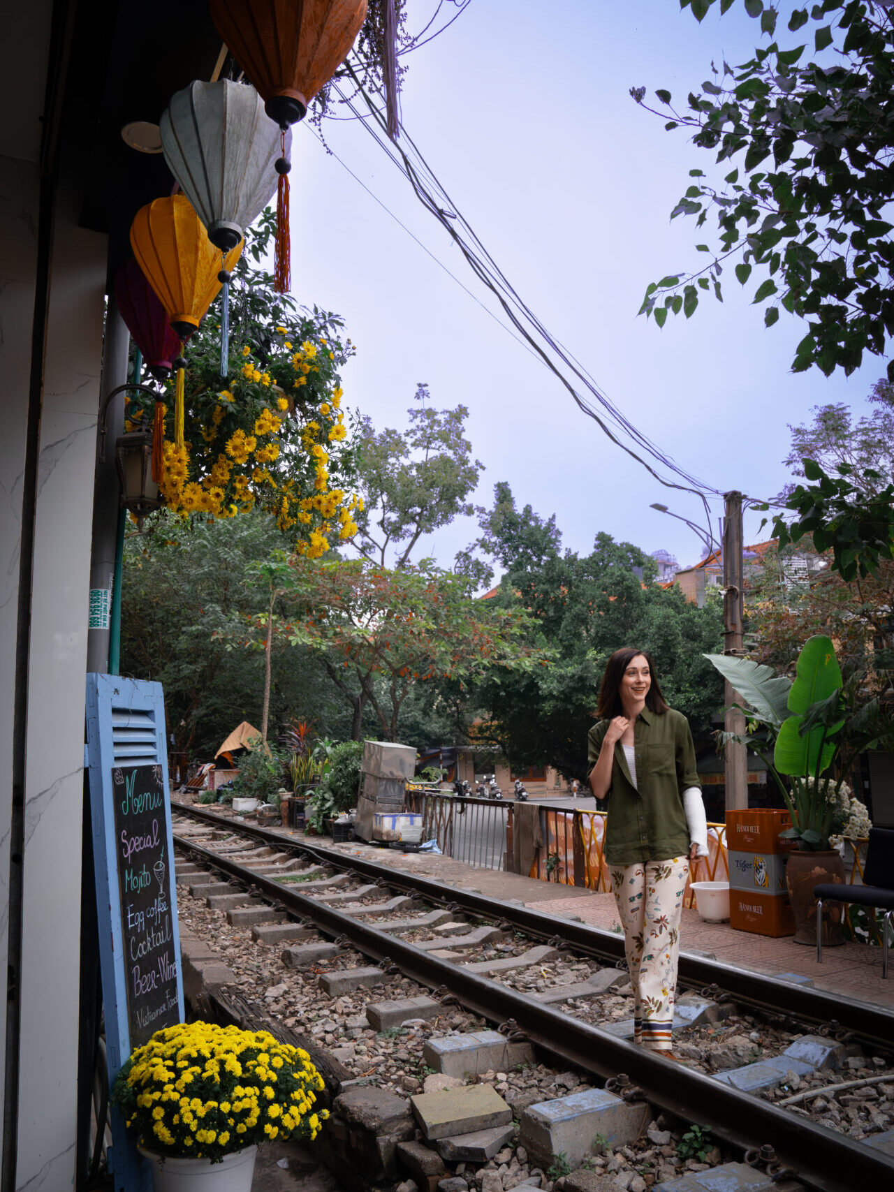 Travel Blogger Jordan Gassner smiling while walking along Train Street near Phung Hung Street in Hanoi, Vietnam